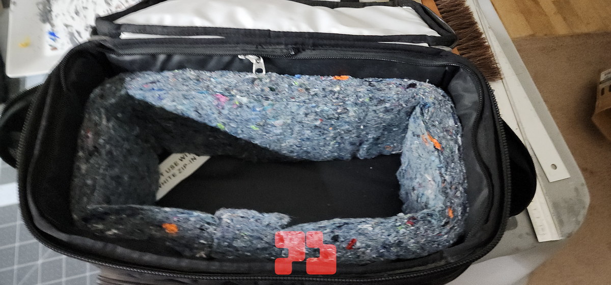 Photo showing the additional side insulation. There is already a thinner layer within the black walls of the cooler bag, too.