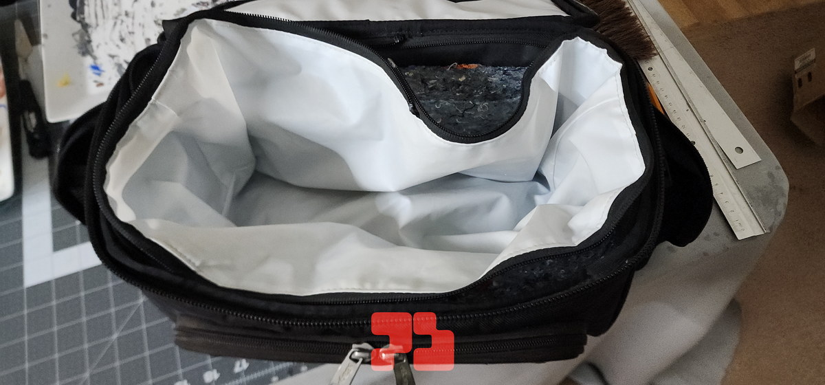 Zipping the liner back into the bag