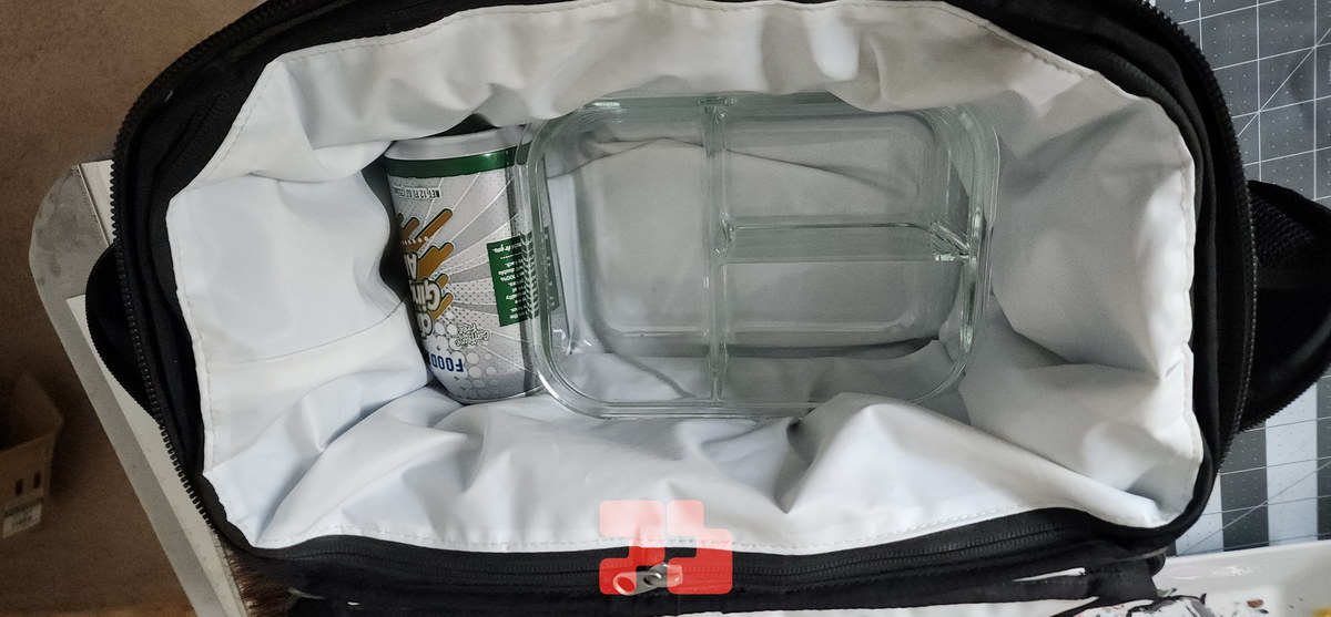 Photo of another multi-part food container I often take lunches in, with a beverage can also inside.